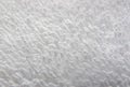 White natural cotton towel background. Texture of white terry towel close-up. White towel macro material.