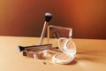 cosmetics and a makeup brush on a table with a mirror Royalty Free Stock Photo