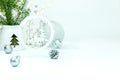 White background with wooden carved christmas tree decoration, green branches, balls and garland lights Royalty Free Stock Photo