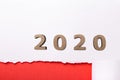 White background with wooden figure of date 2020 over red torn strip of cardboard, new year concept, calendar cover design