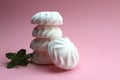 Tasty white marshmallows on a pink background