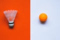 White badminton shuttlecock and orange ball for table tennis on an orange-white background. Royalty Free Stock Photo