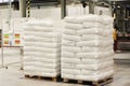 White bags evenly and neatly folded onto a pallet stand in a warehouse Royalty Free Stock Photo