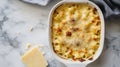 Baked macaroni and cheese in white dish with cheese wedge, ai generated Royalty Free Stock Photo
