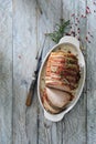 Oven roasted pork loin wrapped with smoked bacon. Royalty Free Stock Photo