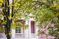 White balcony of pink house of classic style in autumn garden
