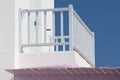 White balcony railing against a blue sky background. Royalty Free Stock Photo