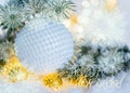 New Year Holiday greeting card. Beautiful ball, pine branches and a garland in the snow. Royalty Free Stock Photo