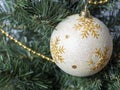 White ball with ornament hanging on a Christmas tree branch. Christmas and New Year concept Royalty Free Stock Photo