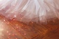 White ballet tutu on wooden floor