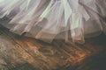 White ballet tutu on wooden floor. Retro filtered Royalty Free Stock Photo