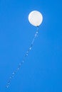 White balloon flies in the blue sky Royalty Free Stock Photo
