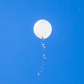 White balloon flies in the blue sky Royalty Free Stock Photo