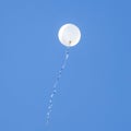 White balloon flies in the blue sky Royalty Free Stock Photo
