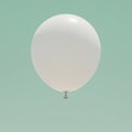 A white balloon floats against a solid, light teal background. It is tied at its stem with a Royalty Free Stock Photo