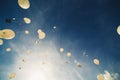 White balloons fly up into the blue sky. The release of festive balloons in the clouds. Air gel balls in the atmosphere Royalty Free Stock Photo