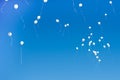 White balloons flying in the blue sky Royalty Free Stock Photo