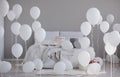 White balloons in grey bedroom interior with king size bed, real photo with copy space on the empty wall Royalty Free Stock Photo