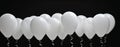 White balloons isolated on black background, wide panoramic design for website banner or flier, usable as header. Anniversary, Royalty Free Stock Photo