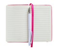 White ballpoint pen on the opened notebook with lined paper in a pink cover isolated on a white background copy space