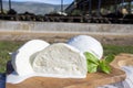 White balls of Italian soft cheese Mozzarella di Bufala Campana and Mediterrane Italiana buffalo raised on Italian cheese farm for Royalty Free Stock Photo