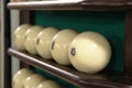 White balls on the shelf-stand for billiard balls in one row for playing Russian Billiards. Russian sport and fun for