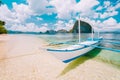 White banca island hopping boat at Las cabanas beach with amazing Pinagbuyutan island in background. Beautiful landscape Royalty Free Stock Photo