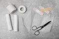 White bandage rolls and medical supplies on light grey table, flat lay Royalty Free Stock Photo