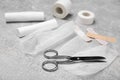 White bandage rolls and medical supplies on light grey table Royalty Free Stock Photo