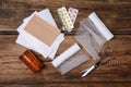 White bandage rolls and medical supplies on wooden table, flat lay Royalty Free Stock Photo