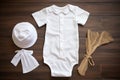 white baptism outfit lying flat on a wooden table