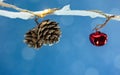 White bare tree branches decorated by christmas garland lights with pine cones and red jingle bell Royalty Free Stock Photo