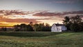 A white barn against the dawn sky in a rustic country scene