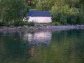 white barn on the edge of the fjord