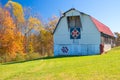 Red roofed white barn with quilts in West Virginia