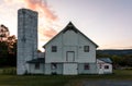 White Barn and silo at sunset late summer Royalty Free Stock Photo