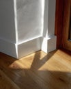 White Baseboard Corner in Sunlit Room Royalty Free Stock Photo