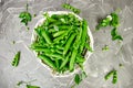 White Basket with fresh green peas on grey background Royalty Free Stock Photo