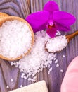 The white bath salt in a wooden cup with a spoon on a wooden tab Royalty Free Stock Photo