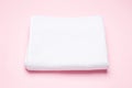 White bath towel on pink background, bathroom and spa accessory
