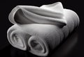 White bath towels isolated on black background