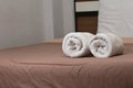 White bath towels roll on a bed in the hotel suite Royalty Free Stock Photo