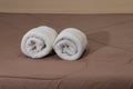 White bath towels roll on a bed in the hotel suite Royalty Free Stock Photo