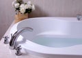 White bath tub with faucet and mozaic tiles Royalty Free Stock Photo