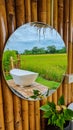 white bath tub outside on vacation at a homestay in Thailand with green rice paddy field Royalty Free Stock Photo