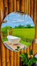 white bath tub outside on vacation at a homestay in Thailand with green rice paddy field Royalty Free Stock Photo