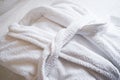 White Bathrobe on bed in bedroom, close-up. The concept of rest in a hotel Royalty Free Stock Photo