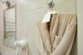 White Bathrobe on a hanger at bathroom Royalty Free Stock Photo