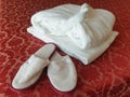 A white bathrobe, slippers and towel Royalty Free Stock Photo