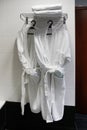 Fresh white bathrobes hanging Royalty Free Stock Photo